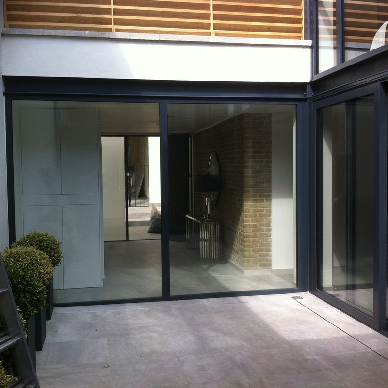Floor-to-ceiling sliding doors opening to courtyard in Harlesden