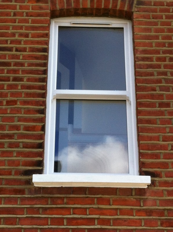 uPVC sash window on Victorian red brick house in Harlesden